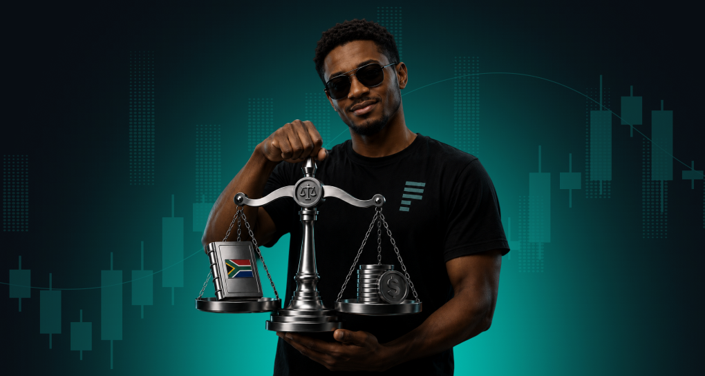 South African forex trader in FXPrimus t-shirt holding balance scales weighing a South African flag against US dollar coins, candlestick chart background